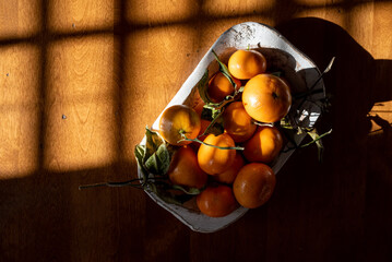Fresh mandarin oranges on a dining table in natural light