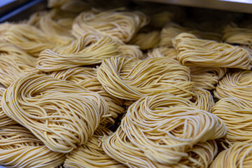 Artisan production of noodles in an Italian restaurant. Yellow noodles in the drying process