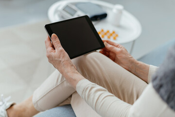 woman with a digital tablet sitting in a medical office.