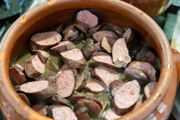 Ceramic pot with feijoada, typical Brazilian food. In a restaurant in Brazil