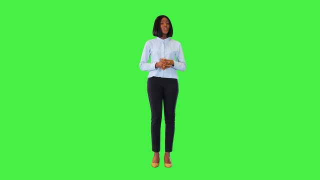 Young black businesswoman presenting advertising product or service speak confident, point finger up on a Green Screen, Chroma Key.