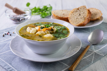 Vegetarian vegetable soup with dumplings in a white porcelain plate. Healthy and dietary food. Vegetarianism. Selective focus, close-up.