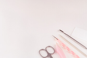  Background with professional manicure tools in pastel colors.