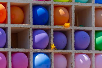 Colored balloons in a dart shooting range.