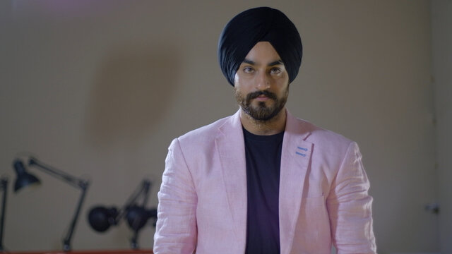 Young Indian Man Wearing A Turban And A Pink Suit