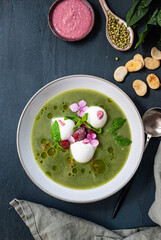 Cremy spinach soup with crumpled, olive oil, mozzarella and rasberries