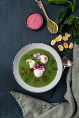 Cremy spinach soup with crumpled, olive oil, mozzarella and rasberries