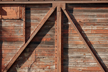 the side of a vintage wooden railway car, peeling paint