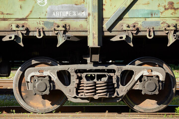 Close-up of a wheelset spring on a railway boxcar. Power railway vehicles that are used for transporting heavy loads.