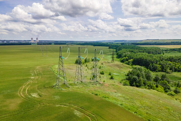 Aerial view of High voltage transmission on industrial electricity line tower. Energy technology with overhead power line