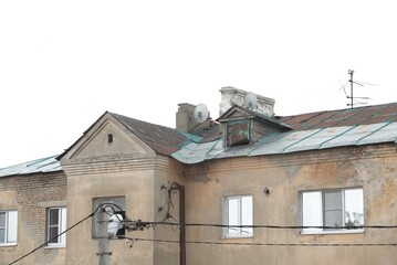 Fototapeta na wymiar Metal roofs of an old house against the sky