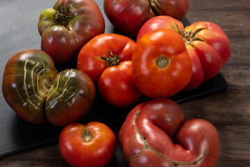 Organic tomatoes at farming market displayed for sale. Organic farming or gardening concept.