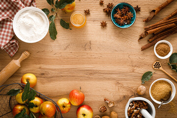 Culinary background. Cooking Thanksgiving autumn apple pie with fresh fruits and walnuts on wooden table, top view