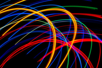 colored lines of lights on a black background