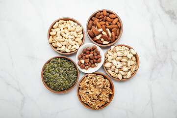 Different kind of nuts in wooden bowls