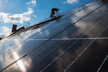 Photovoltaic panels on the roof and iengineer in the background