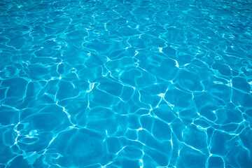 Fototapeta na wymiar Blue ripped water in swimming pool. water surface background. summer background