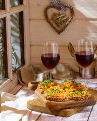 Bruschetta with olive tapenade and fresh tomatoes on cutting board. Wooden background. Close up.