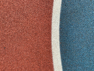 Blue and red rubber surface anti-traumatic safety tile for workout sports playground in public park...