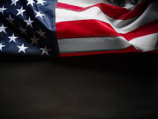 Fototapeta premium American flag. Association with patriotism, pride in their country. Simple black background. There are no people in the photo. There is an empty space for your insert. Close-up.