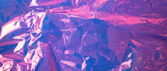 holographic blue purple background. Crumpled iridescent foil real texture. Synthwave. Vaporwave...