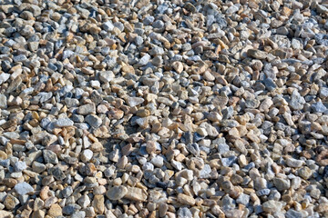 Natural Gray Granite Chippings. Crushed Stones Background Top View. Macro Photo of Broken Stone or Crushed Rock Texture.