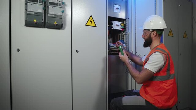 danger work with electricity, engineer is checking function of circuit breaker