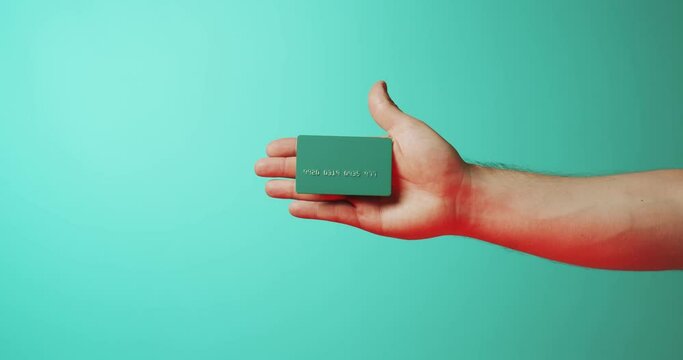 Close up hands showing magic trick with template mockup Bank credit card with online service on green background