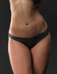 Fototapeta na wymiar Abdominal press, flat belly. Woman body beauty healthcare. Close up of female body in black panties.