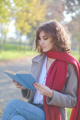 Portrait of a woman reading a book in the park