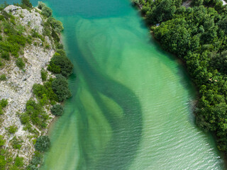 Aerial drone view of colorful mountain river. Crystal clear river flowing in valley, view from above. Landscape. 