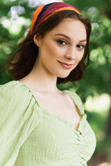 Young woman looking at camera outdoors during summer
