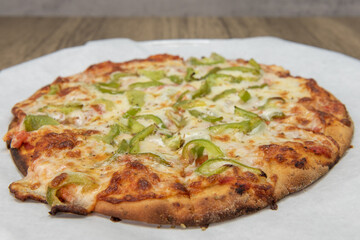 Health conscious pizza with melted cheese and chopped bell peppers and a special crust