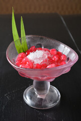 asian snow iced kacang with red ruby mango fruit  and sweet sugar syrup in glass Thai dessert halal menu
