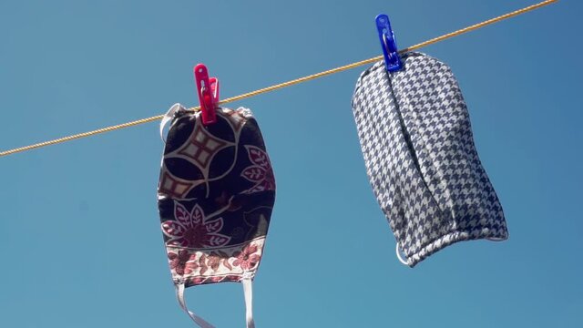 Cloth masks that are being dried under the sun light
