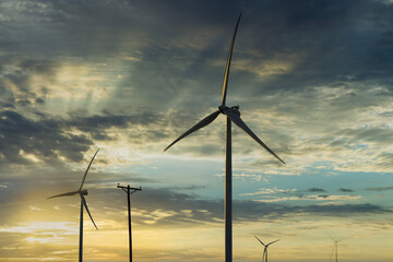 Wind turbines windmill energy farm the beautiful sunset in Texas