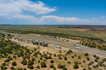 Obraz premium Aerial view of highway in desert Arizona of highway rest area with large car park for cars trucks