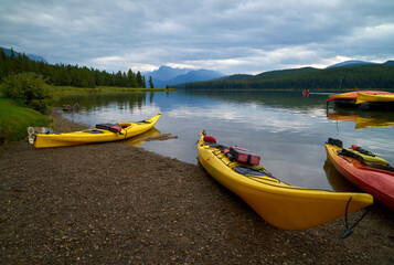 Fototapeta na wymiar Maligne Lake Kayaks. Kayaks on the shore of Maligne Lake, Alberta.