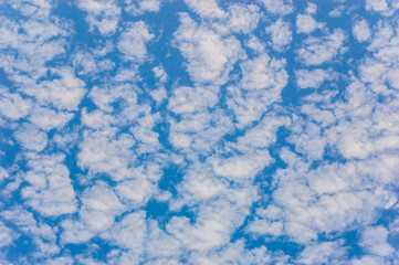white fluffy clouds in blue sky.