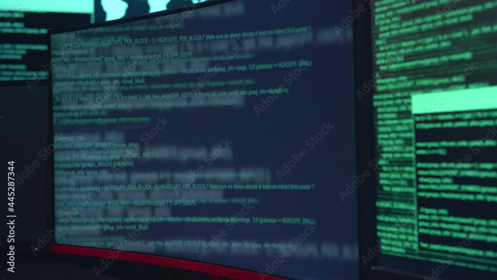 Wall mural code on multiple computer screens, cyber attack