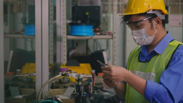 Asian factory worker technician man operating measuring steel size of detail with digital vernier caliper at workshop