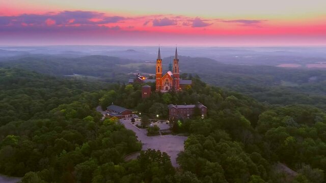 Holy Hill Basilica, quiet beauty and soaring architecture in the twilight sky, moving aerial view.
