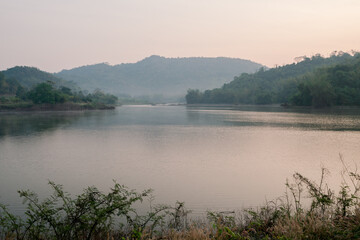 The lake in the morning light that the sun is rising There is a mountain back view.