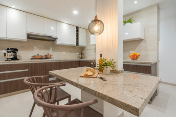 Kitchen counters, dining area and extractor hood in contemporary kitchen