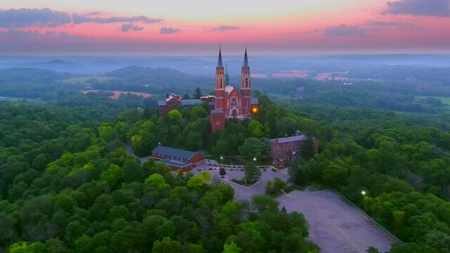 Holy Hill Basilica, quiet beauty and soaring architecture in the twilight sky, moving aerial view.
