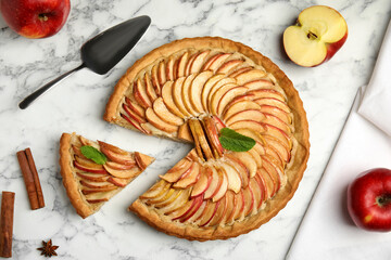 Delicious apple pie and ingredients on white marble table, flat lay - obrazy, fototapety, plakaty