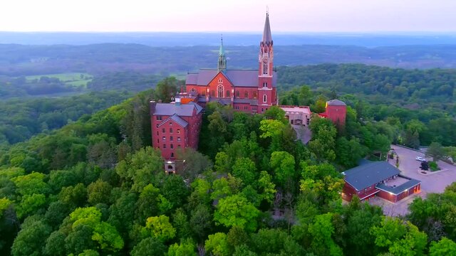 Holy Hill Basilica, quiet beauty and soaring architecture in the twilight sky, moving aerial view.
