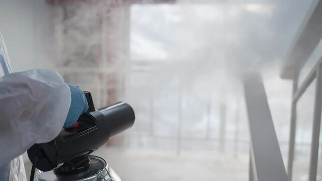 disinfecting fog for killing coronavirus in public place, sanitizing by machine with sanitizer-mist - Powered by Adobe