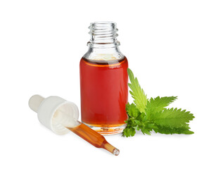 Glass bottle of nettle oil with dropper and leaves isolated on white