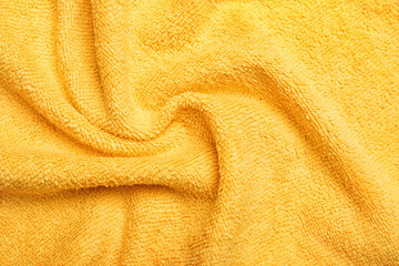 Fototapeta na wymiar Crumpled orange microfiber cloth as background, closeup